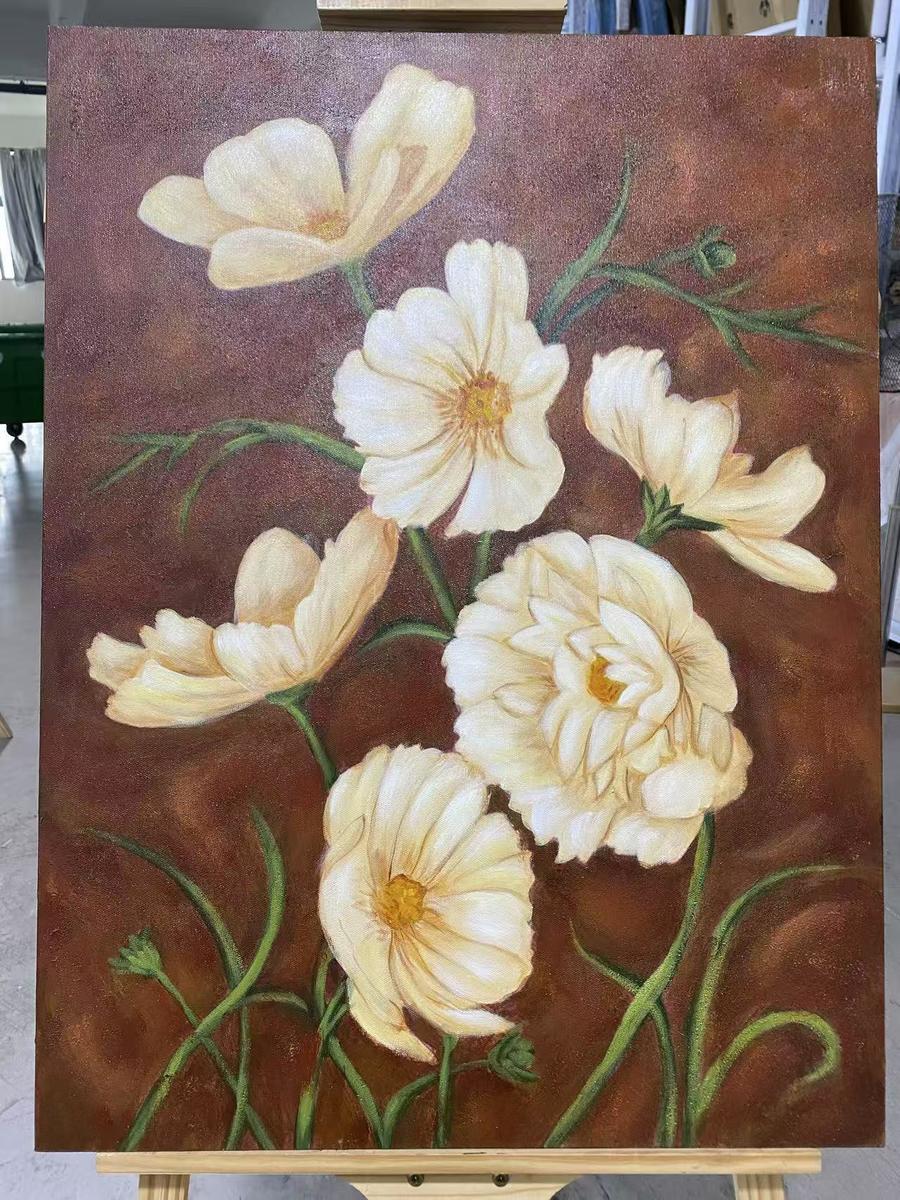 Cream cosmos flowers against vintage brown background